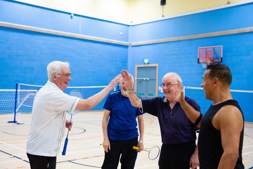 Group of seniors doing a gentle fitness class together in a bright hall